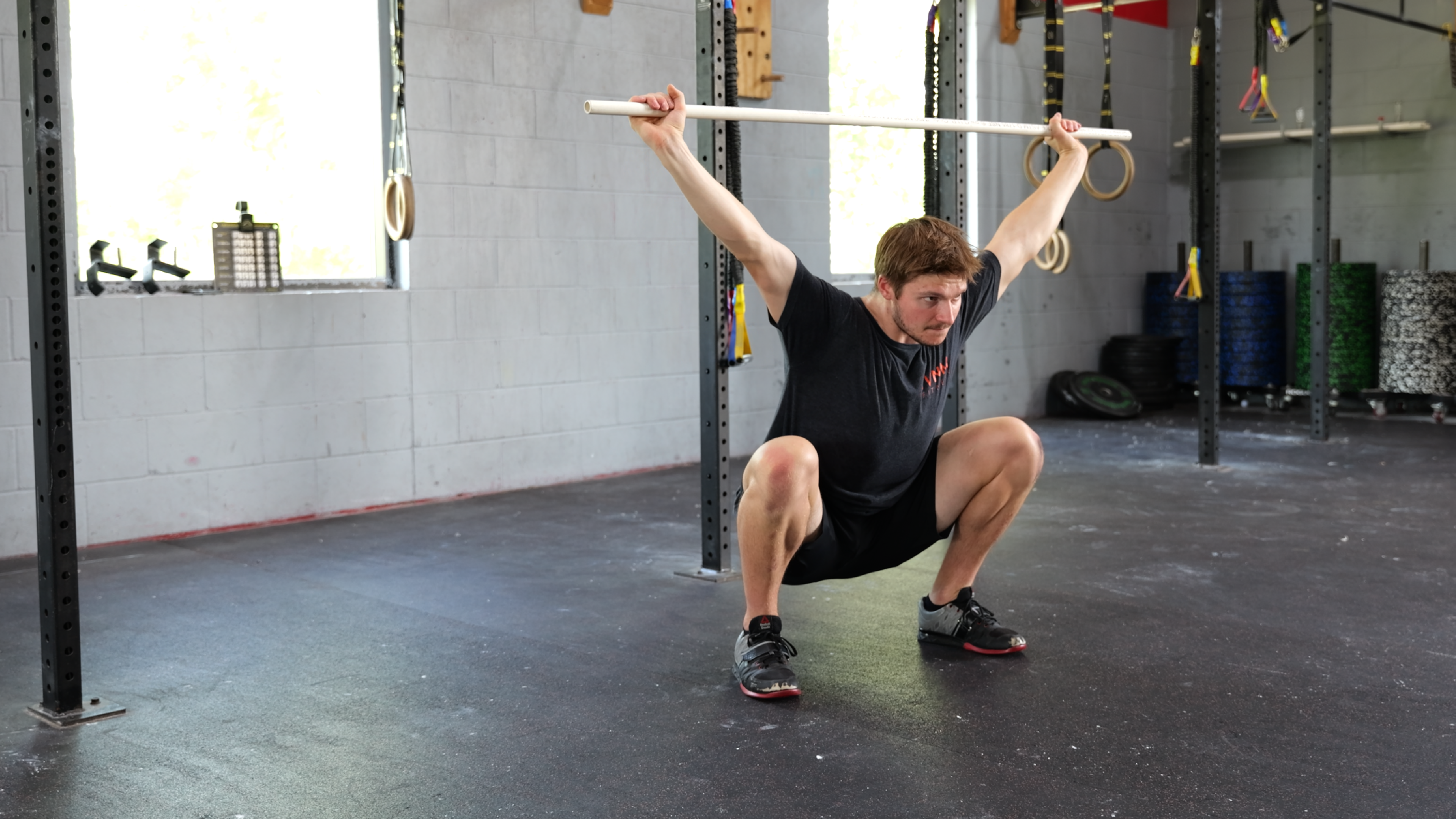 Athlete performing Olympic lifting — snatch or clean and jerk technique work